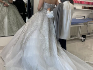 Photo of a bride being fitted for wedding gown alterations at Door to Door Cleaners