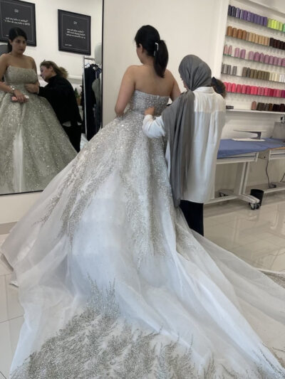 Photo of a bride being fitted for wedding gown alterations at Door to Door Cleaners